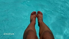 Feet in the pool with a lot of water Thumb